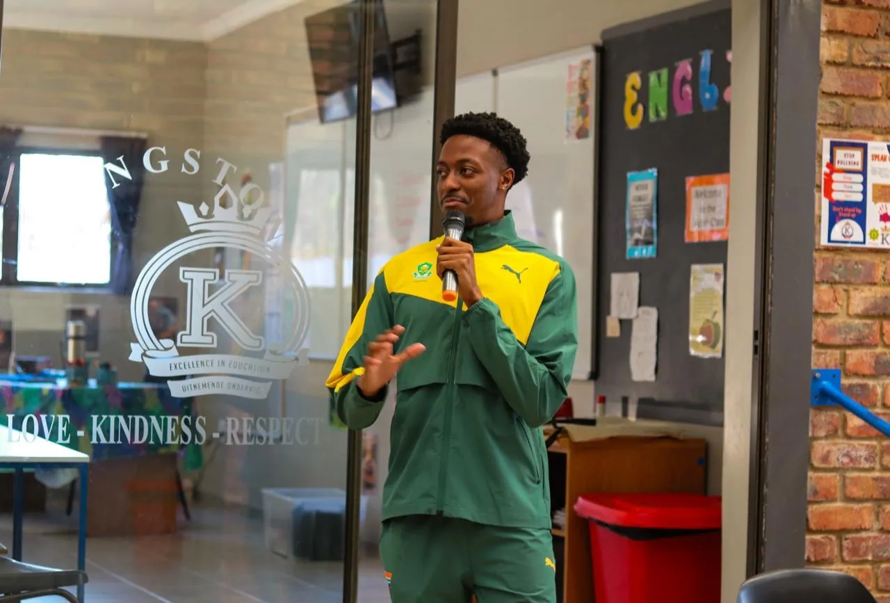 Sihle addressing students in a school hall