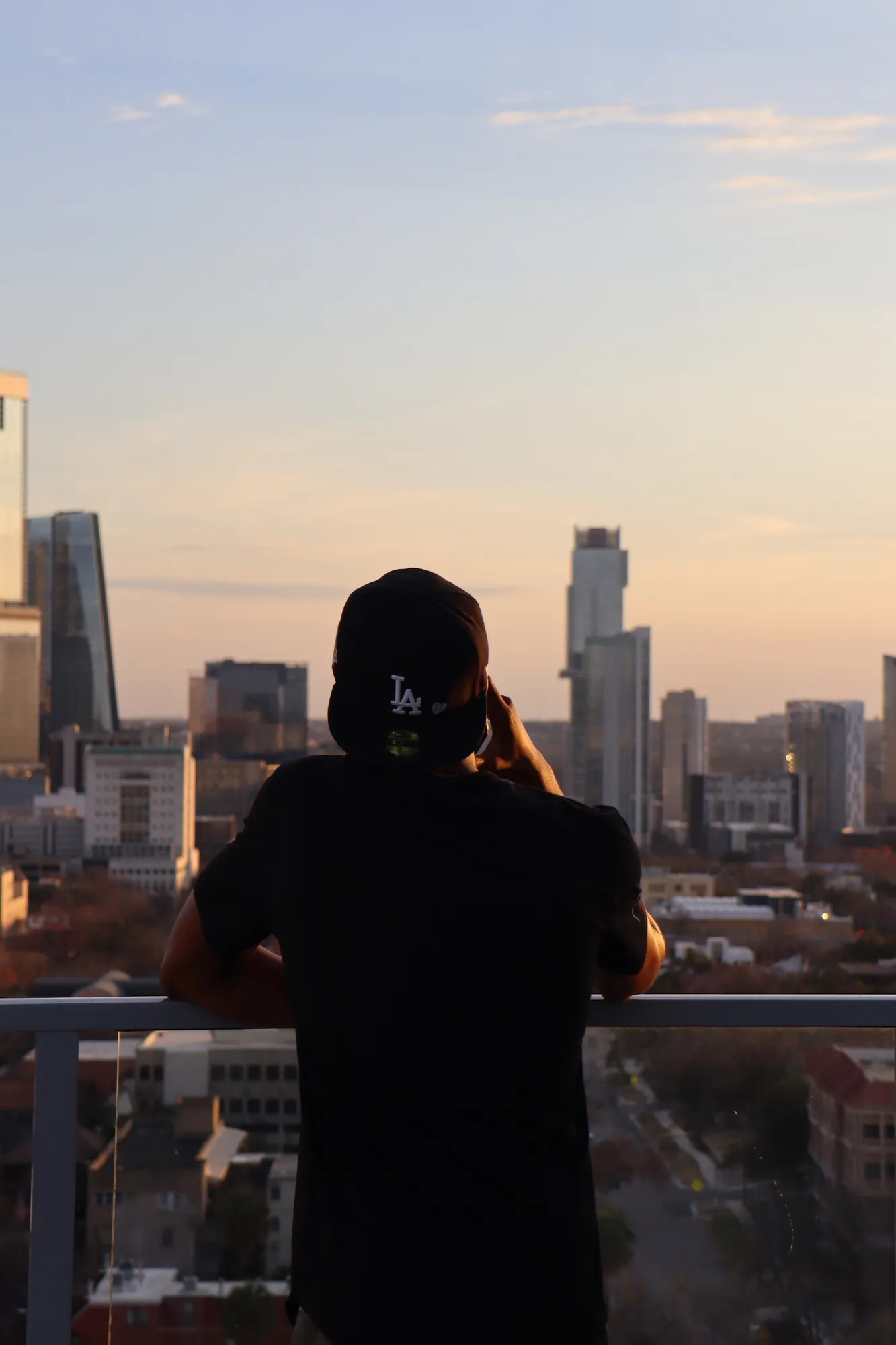 Sihle looking out at the Austin skyline at dusk