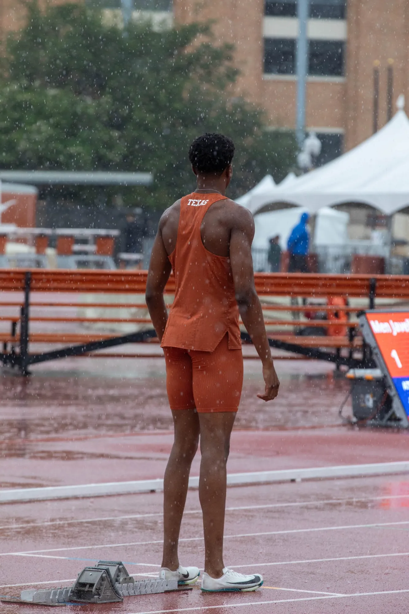 Sihle standing alone on a wet track in the Texas kit